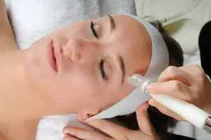 Young woman is getting beauty face treatment at spa